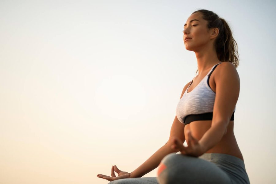 low-angle-view-woman-with-eyes-closed-practicing-yoga-against-sky-copy-space